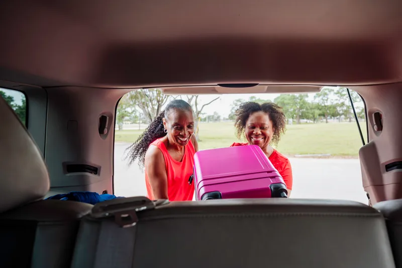 A black SUV loaded with luggage for a family trip