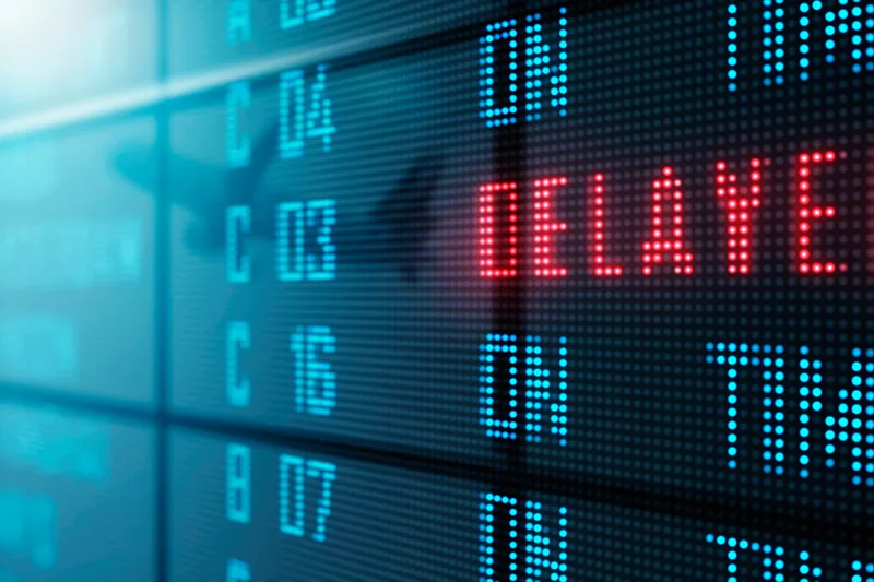 A flight status board showing delays